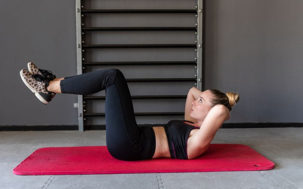 Athlete performing ab exercise Reverse Crunches