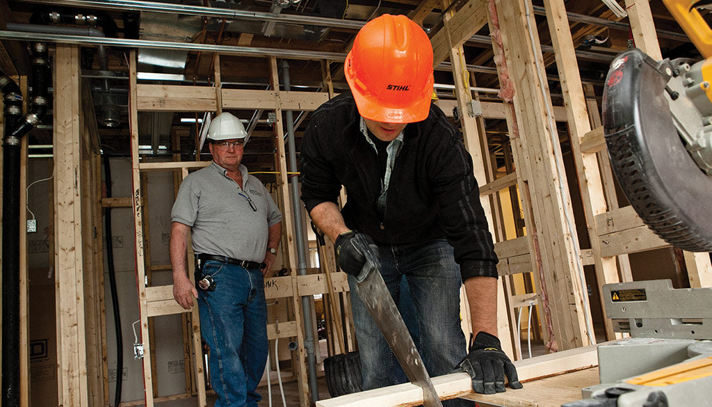 Two people on a construction site.