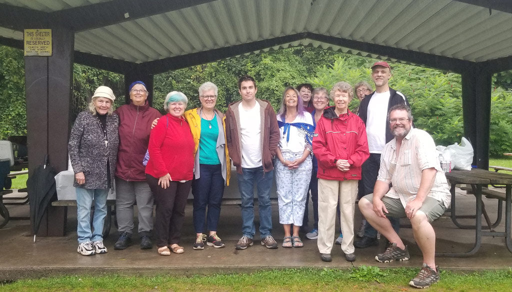 A group of people in a pavilion smiling for the camera.