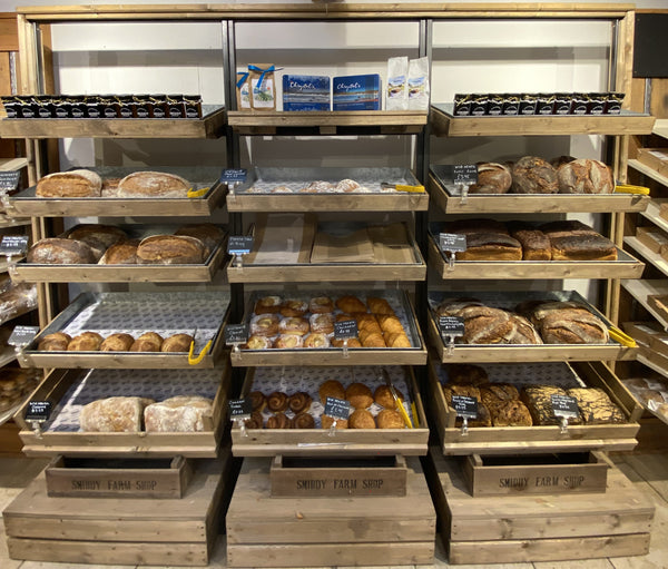 Shelves at the Smiddy Farm Shop displaying fresh bread and pastries from Wild Hearth Bakery