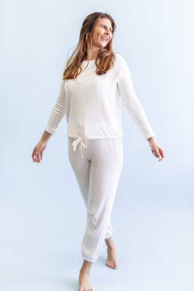 Girl in White Lounge Set on a Blue Backdrop