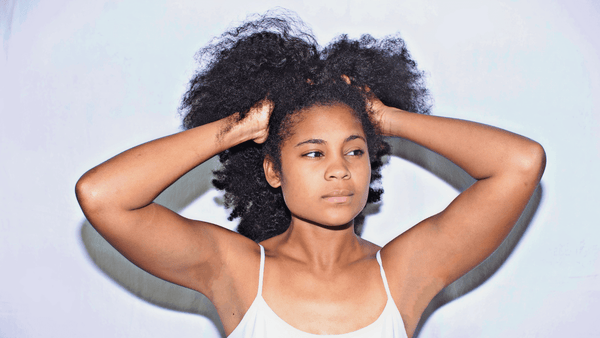 American african woman touching curly hair