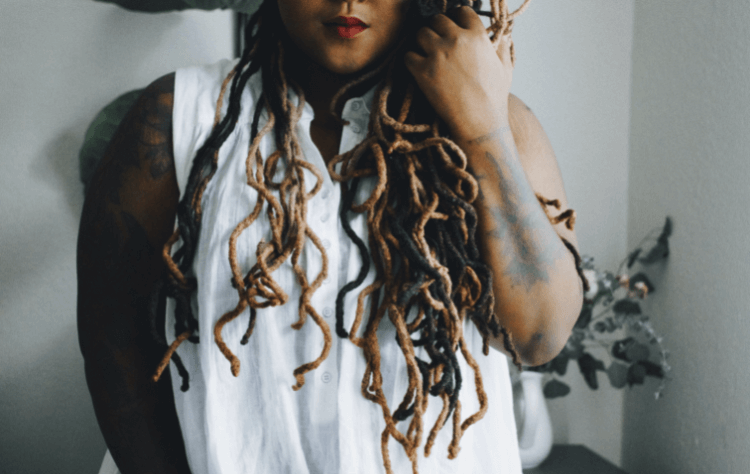 American african woman dreaded hair tattoed wrist