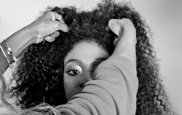 American african woman curly hair touching by a another person
