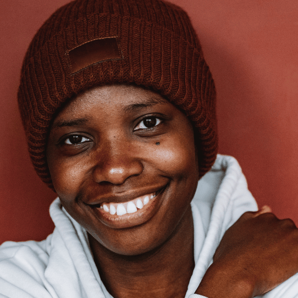 African american woman wearing beanie smiling