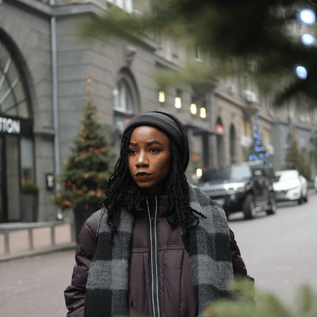 African american woman wearing a beanie walking on a high busy street