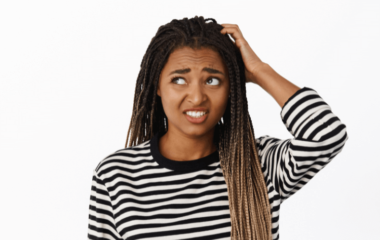 portrait confused black girl looking awkward unsure scratchin head looking aside with indecisive face expression white background