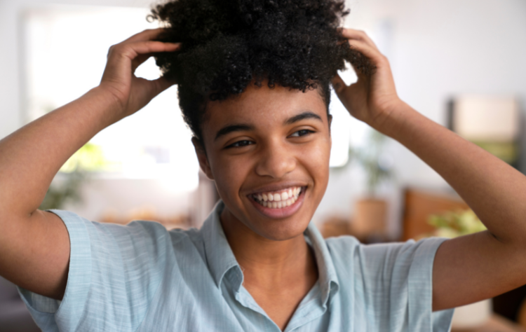 smiley young american african woman taking care afro hair