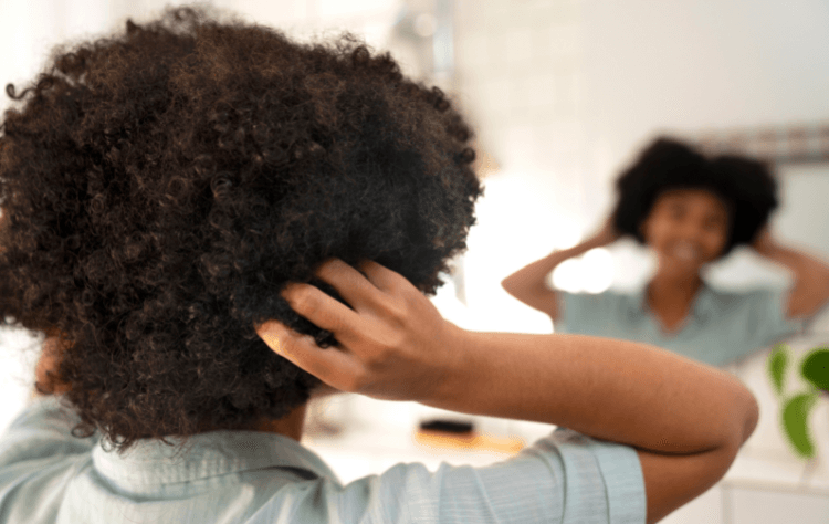 young black person taking care afro hair