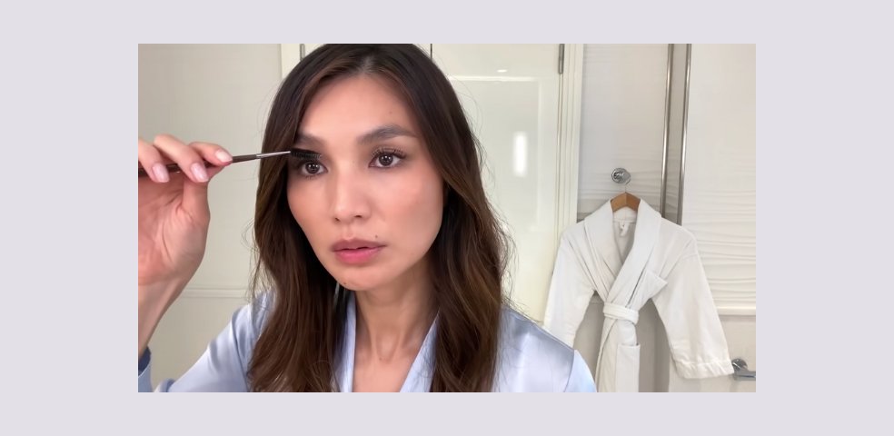 Gemma Chan brushing her eyebrows