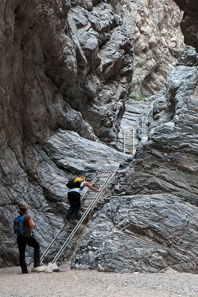 Hikers on a ladder in the Mecca Hills Wilderness, CA