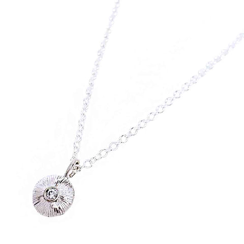 Engraved tiny round sterling silver pendant with a .05ct diamond set in the center on an 18 inch sterling silver chain by Corey Egan at Bezel & Kiln Seattle, WA