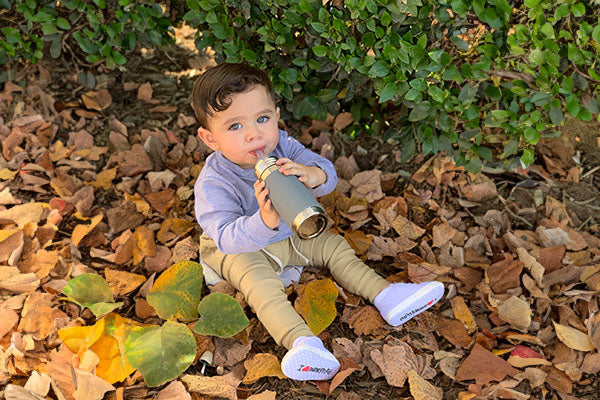 Young toddler using a Pura Stainless sustainable water bottle.