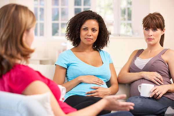 Image of a pregnant woman support group, with women talking to one another.