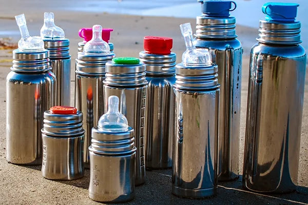 Stainless steel water bottles on the beach