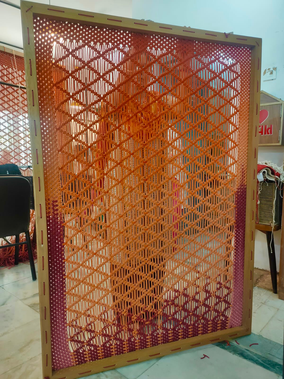 A unique wall frame hand-knotted by Ranjanben and Dipaliben for a lovely customer
