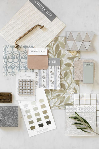 a flat lay featuring soft greens and pink with delicate finishes and patterns