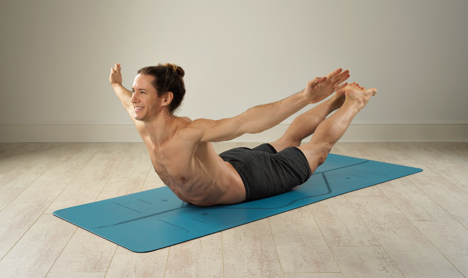 A man doing the Locust Pose (Salabhasana) which is one of the best back bending yoga poses