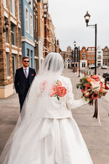 Image of bride with custom Wink Ink Design Co leather jacket featuring bold hand painted peonies from 2020 Wedding in Edmonton, Alberta, Canada. Photo Credit: Sarah Mavro Photography