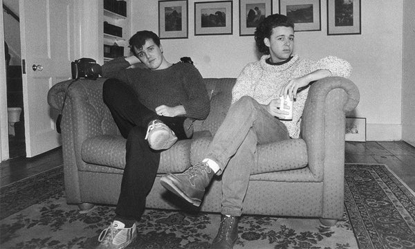 Tears for Fears - Roland Orzabal and Curt Smith sat on a sofa in black and white, around 1983