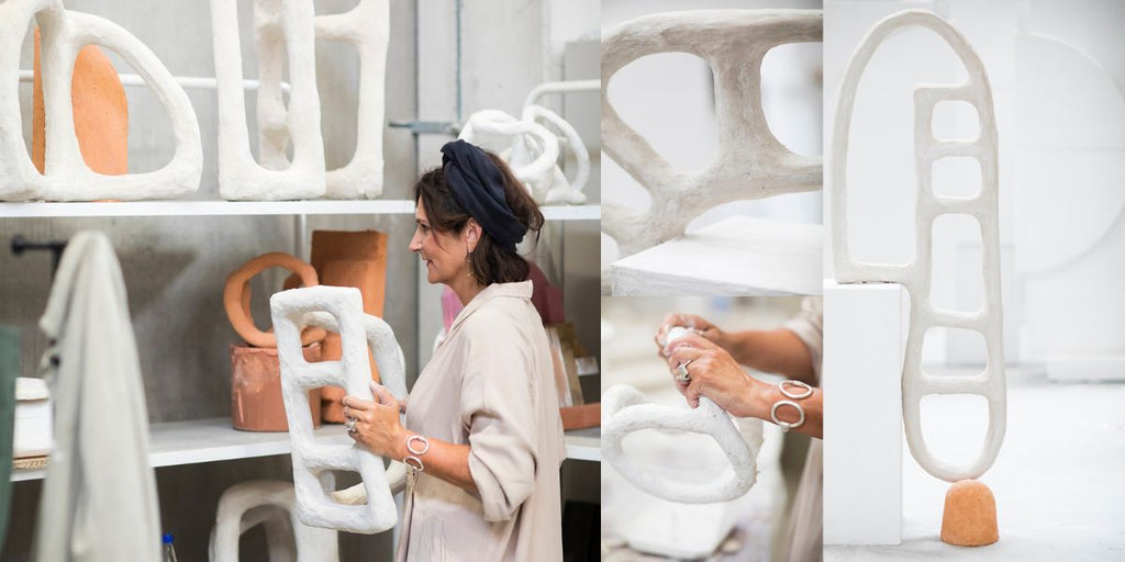 A photo of marie michiellsen with her sculptures and plant pots for Serax on makers and merchants website news post called a moment with marie michiellsen