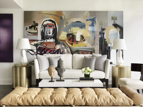 Living room with large abstract print on the wall and two lamps