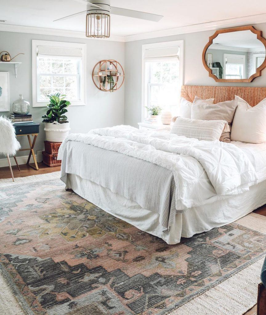 Nesting with Grace bedroom with accent wall paper and real plants and Ronan caged ceiling fan by Hunter