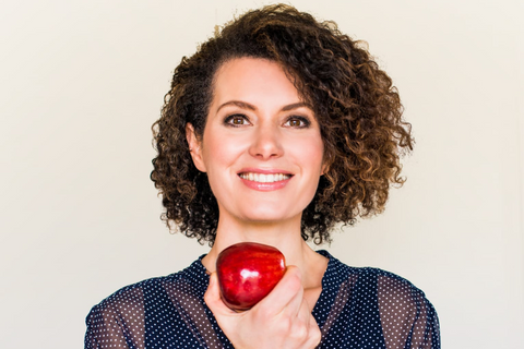 Sinéad Bradbury MSc SENr Holding an apple