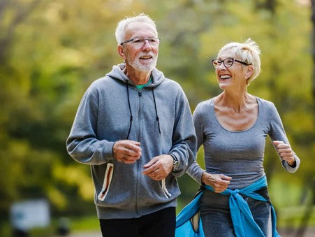 A happy older couple doing some outdoor exercise together.