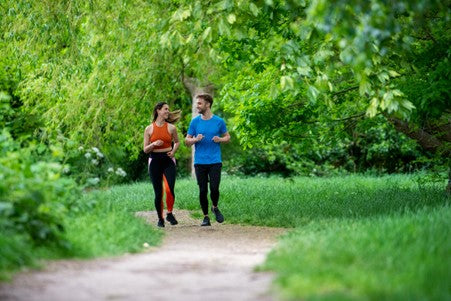 Two people running along a path