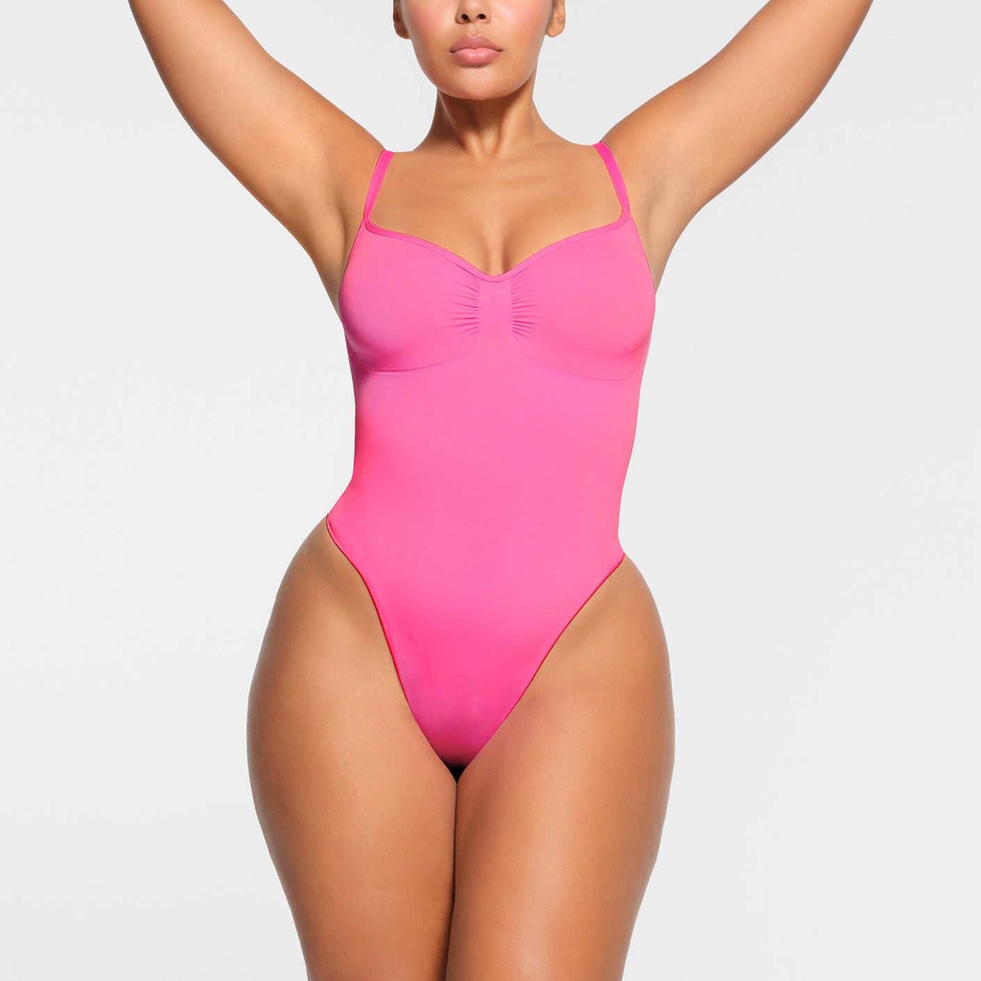 SEAMLESS SCULPT THONG BODYSUIT | PINK ON A MODEL FRONT VIEW