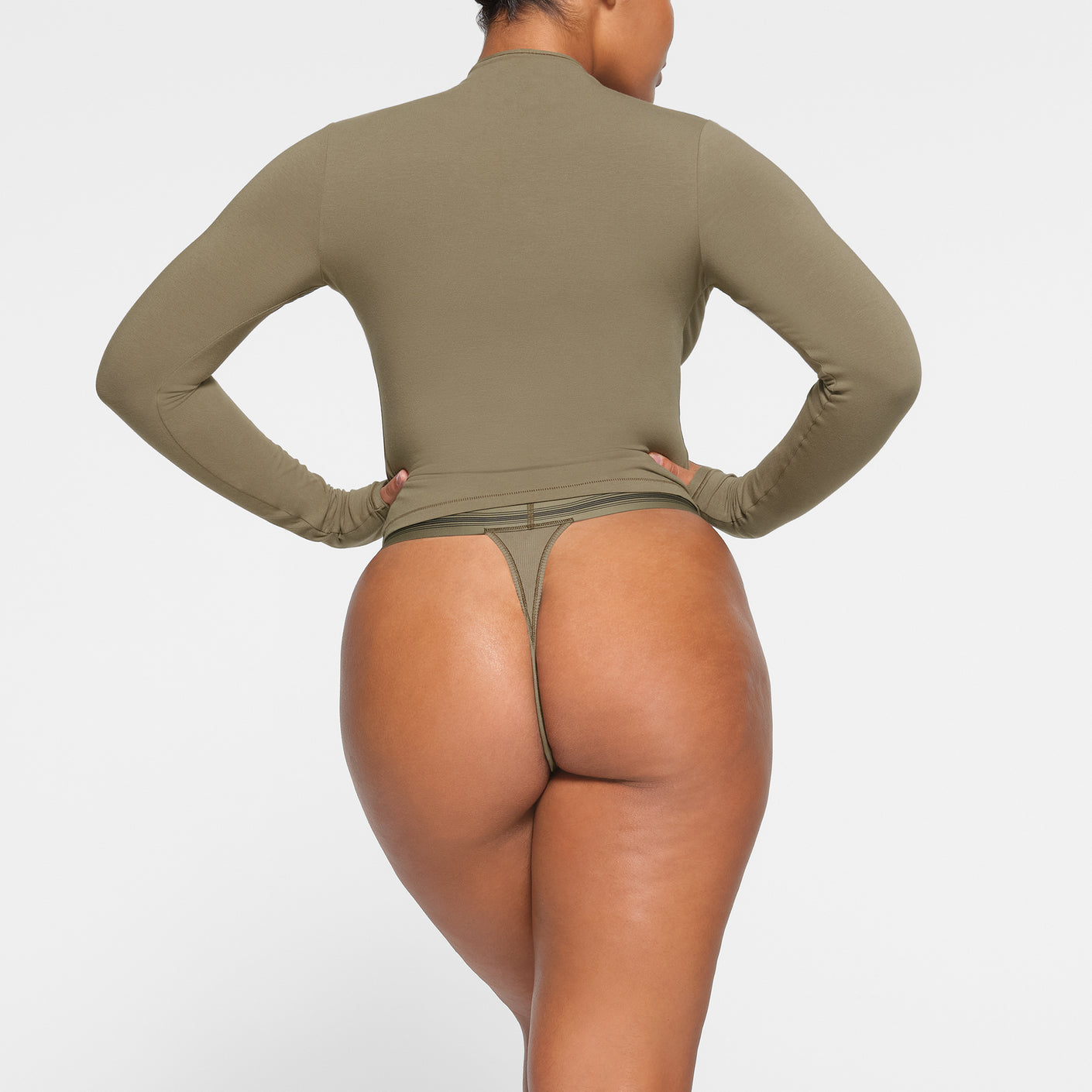 SKIMS - The soft and stretchy Cotton Jersey Mock Neck Tank, Dipped Front  Thong and Muscle Bodysuit in Soot — available now in sizes XXS - 4X. Shop  the Cotton Collection