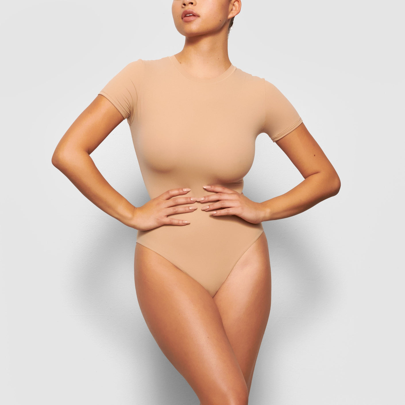 Skims Soft Smoothing Seamless Thong Bodysuit In Clay color size