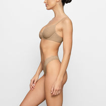 SKIMS - Kim Kardashian West wears the Scoop Neck Bra ($32) and the Dipped  Front Thong ($19) in Clay. Shop the Fits Everybody collection now at SKIMS.COM  and enjoy FREE SHIPPING on