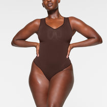 Buy SKIMS Brown Seamless Sculpt Scoop Neck Thong Bodysuit for Women in  Saudi