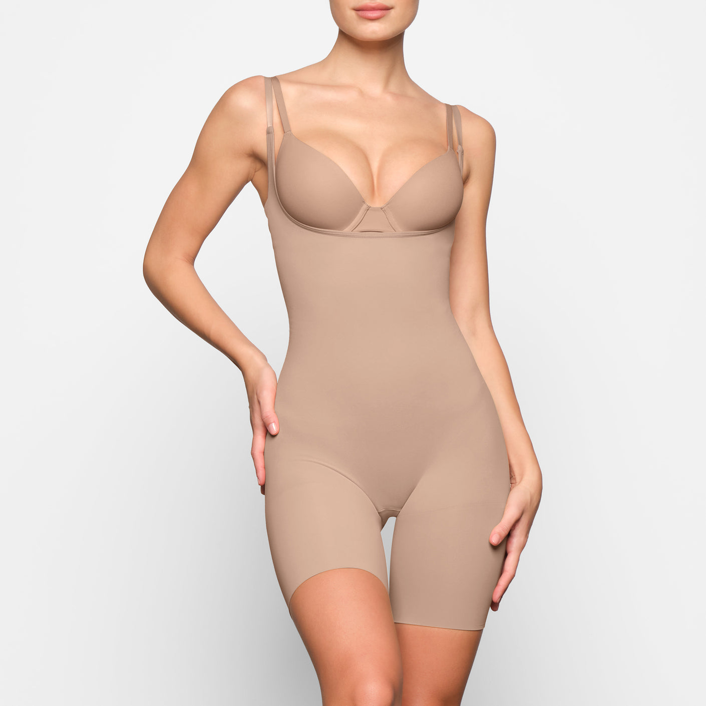 SKIMS on X: The Open Bust Bodysuit holds in your core, shapes and