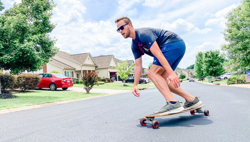 Brandon Fuller skateboarding down a hill in Greenville, South Carolina