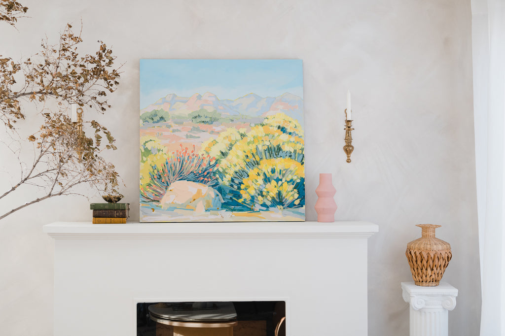 A painting from Amy Dixon's Sunbake collection resting above a fireplace