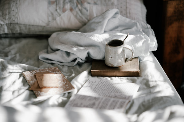 Gratitude journaling with coffee on bed