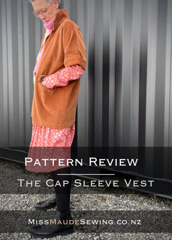 a photo of the cap sleeve coat on a model with a black background with the words Sewing pattern Review The cap sleeve vest missmaudesewing.co.nz