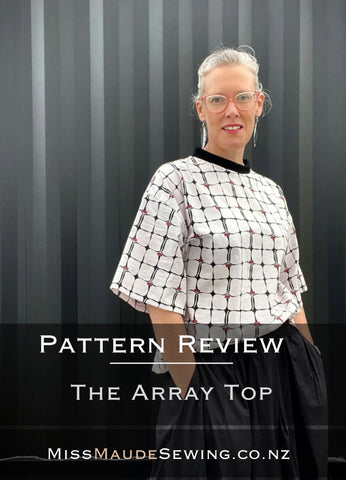 a picture of a pakeha woman wearing a white top with black lines and pale pink flowers with the words Sewing Pattern Review The Array Top by Papercut patterns 