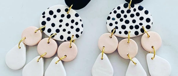 a close up of two clay earrings
