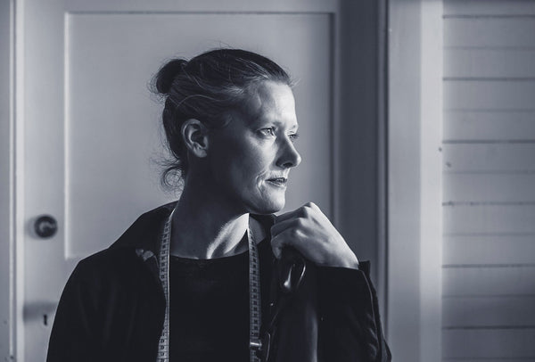 an image of a white woman in black and white staring out of the window.