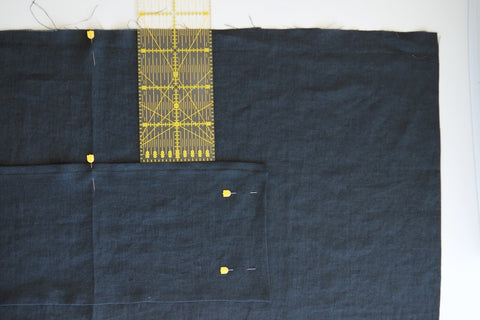 the apron laid out and a long ruler sticking out the pocket