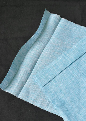 A Close up of turquoise fabric that has been ironed over to mark over the casing