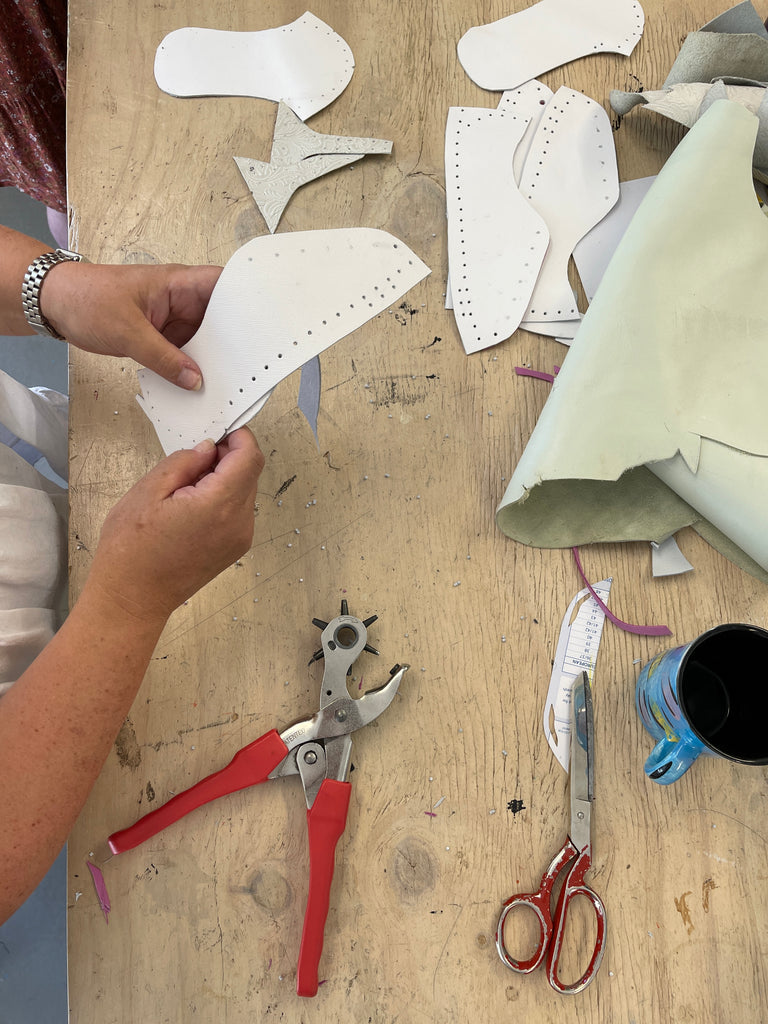 a birds eye view of a lady holding white leather