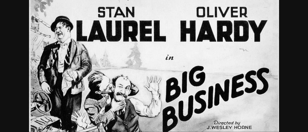 image of a black and white movie poster with laurel and hardy on it. 