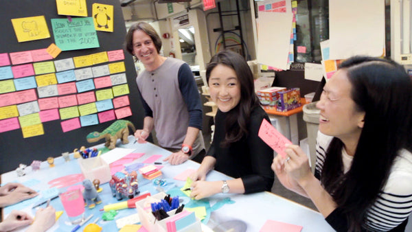 Three people collaborating with post-its