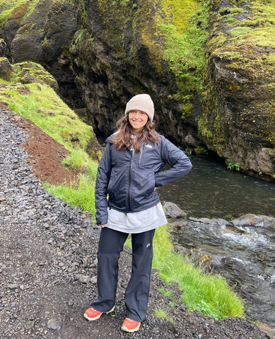 Emily standing by a river.