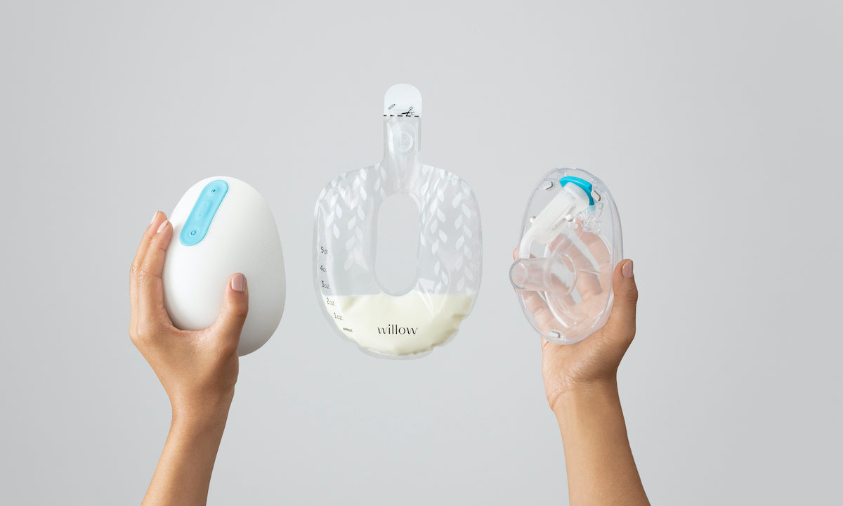 Hands holding different parts of a breast pump device.